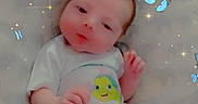 Sammie is registered to the contest to win money with this photo: baby, infant, child, portrait, lying_down, pillow, blanket, nursery, crib, white_clothing, onesie, sleepy, face, eyes, hands, butterflies, sparkles, indoor, close_up, photography