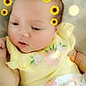 Sammie is registered to the contest to win money with this photo: baby, infant, child, portrait, yellow_outfit, floral_clothing, sunflower_stickers, sparkles, bokeh, blanket, lying_down, indoor, close_up, face, eyes, hair, peaceful, cute, photography, soft_lighting