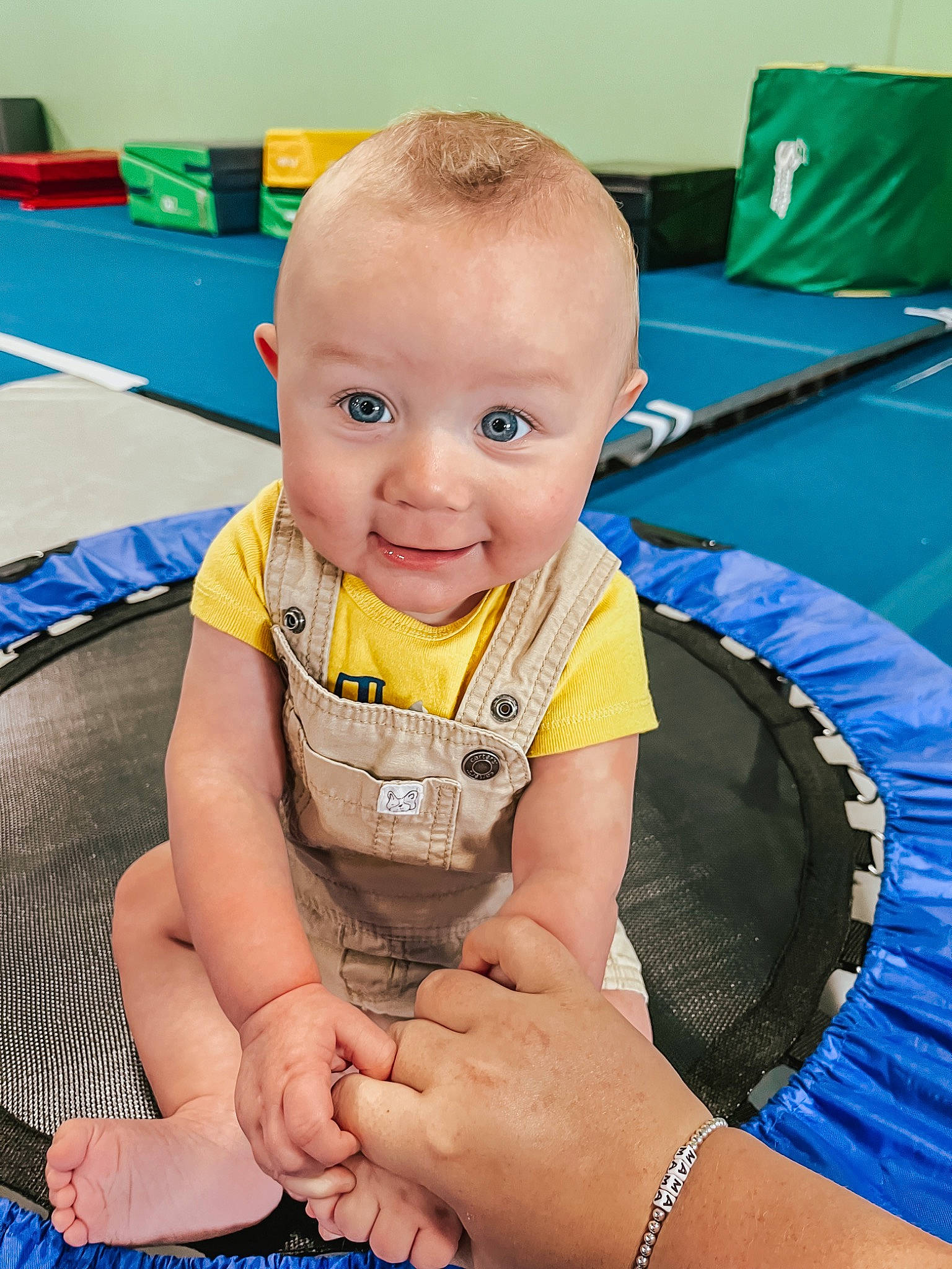 Knox is registered to the contest to win money with this photo: baby, baby_toddler_clothing, blue, cheek, child, electric_blue, flooring, fun, green, happy, human_body, human_leg, joy, leisure, person, play, sitting, skin, smile, thigh