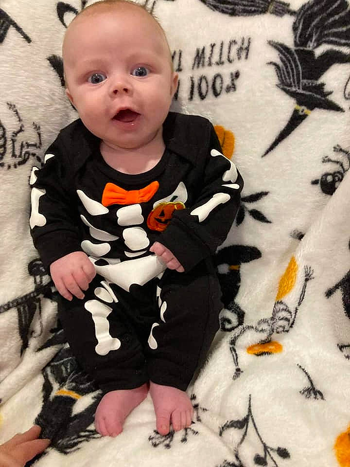 Owen Wyatt is registered to the contest to win money with this photo: baby, baby_products, baby_toddler_clothing, black, child, comfort, cool, flooring, grey, happy, orange, pattern, person, sitting, skin, sleeve, surprise, t_shirt, textile, toddler
