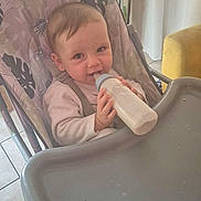 Memphis participe au concours pour gagner de l'argent avec cette photo : baby, bottle, high_chair, milk, infant, kitchen, feeding, child, smiling, indoor, person, seat, cute, hands, table, tile_floor, curtains, toy, container, food