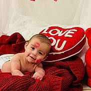 Maximiliano is registered to the contest to win money with this photo: baby, infant, diaper, heart_pillow, red_teddy_bear, roses, kiss_mark, red_blanket, valentine, decorations, smile, lying_down, portrait, plush_toy, cuteness, indoor, photography, soft_texture, love_message, holiday_decor