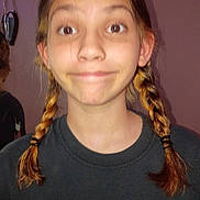 Mia Lee Farmer is registered to the contest to win money with this photo: black_shirt, braids, brown_hair, candid, casual_clothing, child, closeup, expression, face, funny_face, girl, heart_decoration, human, indoor, person, portrait, purple_wall, smile, young_person, youth