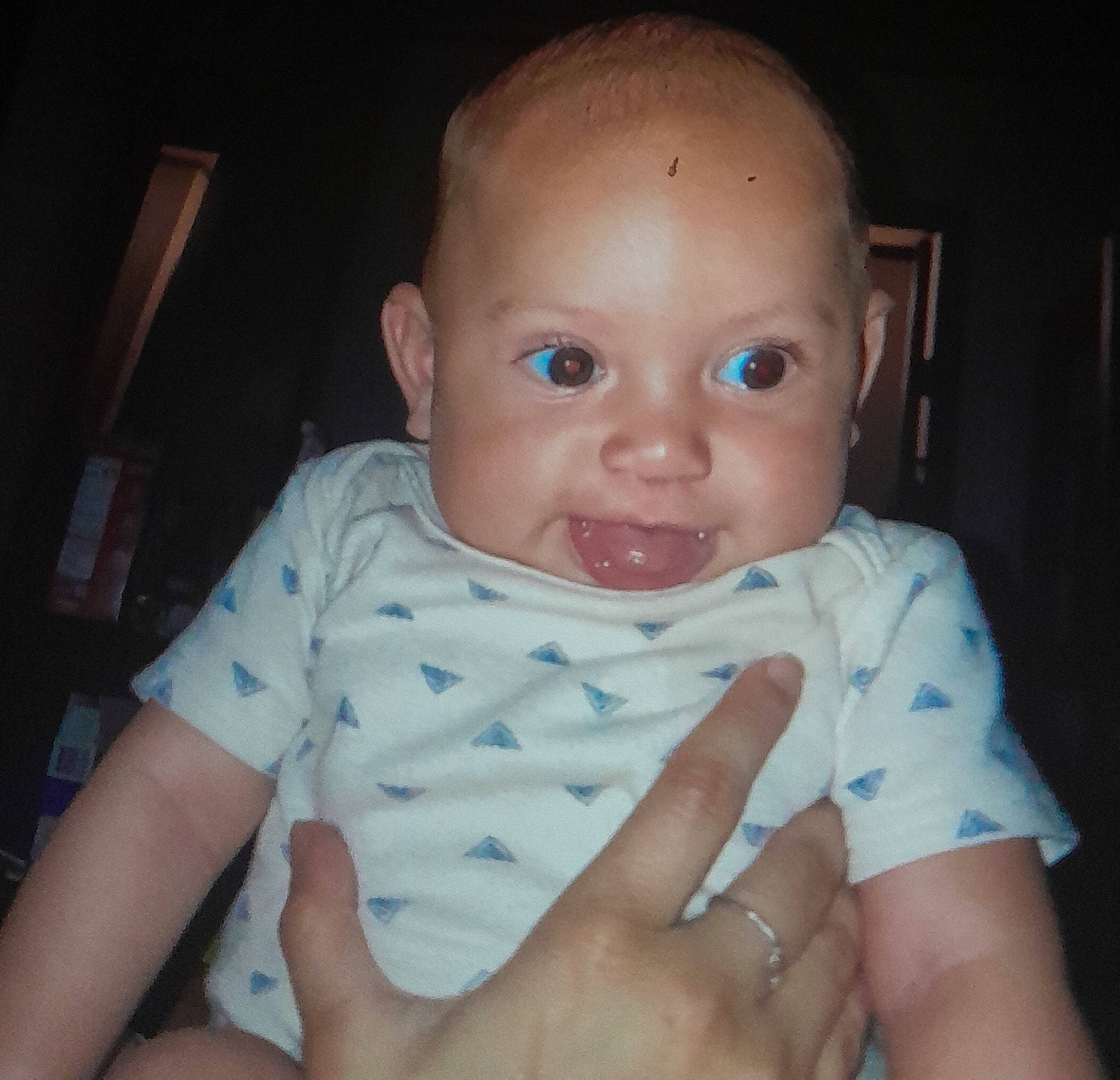 Archie is registered to the contest to win money with this photo: baby, baby_toddler_clothing, cheek, comfort, ear, eyebrow, finger, gesture, hand, iris, lip, mouth, nail, neck, nose, person, skin, sleeve, smile, thumb
