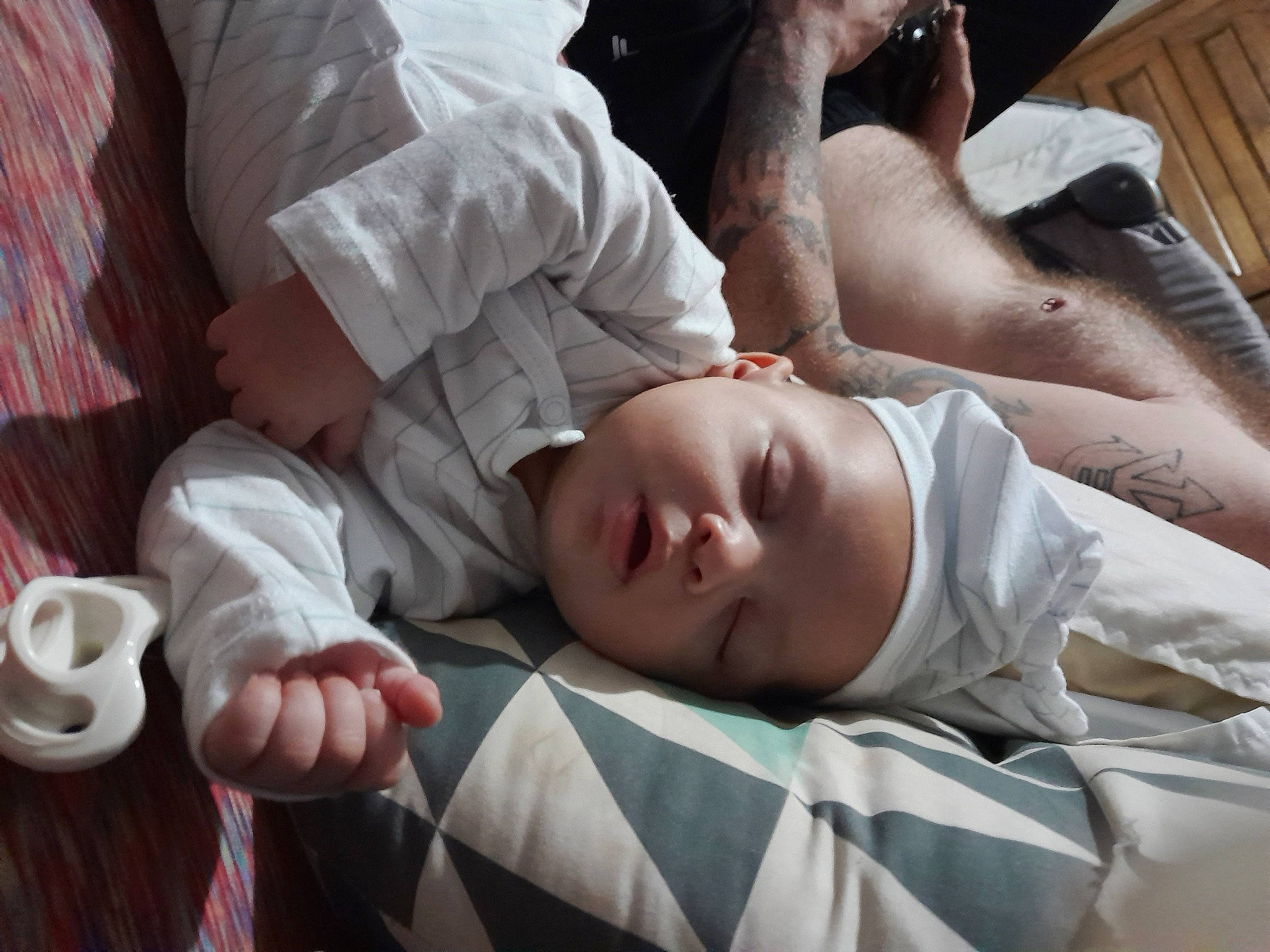 Archie is registered to the contest to win money with this photo: abdomen, bedding, chest, child, comfort, cup, elbow, eyelash, flash_photography, flesh, human_leg, linens, nap, person, room, sitting, skin, sleep, tableware, toddler