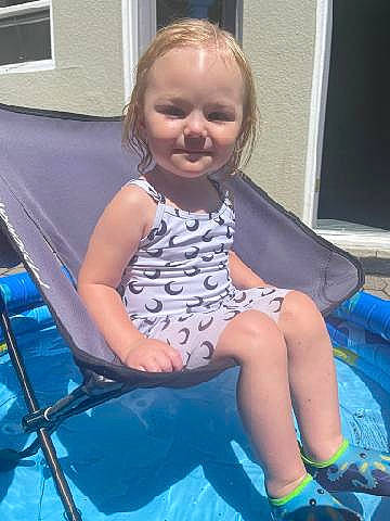 Calliope joined the competition — help win amazing prizes! baby_products, baby_toddler_clothing, chair, child, electric_blue, folding_chair, fun, happy, head, human_leg, knee, lap, leisure, person, play, purple, recreation, sitting, smile, thigh