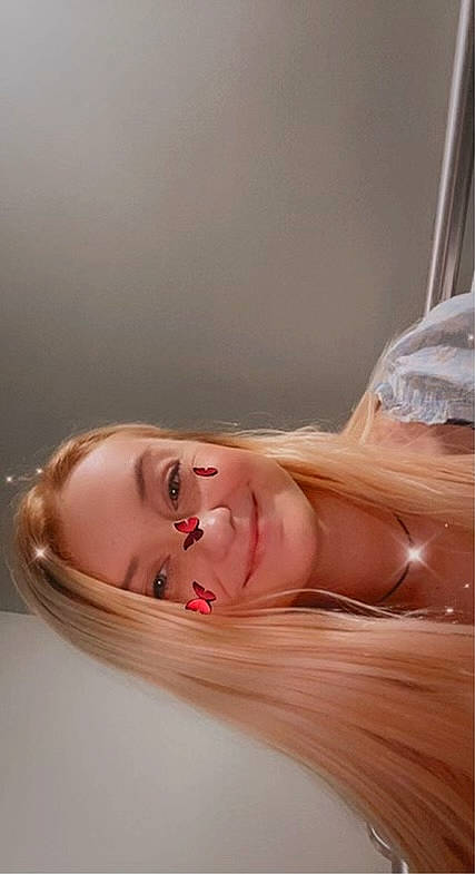 Danielle is registered to the contest to win money with this photo: art_model, brown_hair, cheek, chest, comfort, dress, eyelash, fashion_accessory, flash_photography, human_body, jaw, jewellery, joy, lip, long_hair, neck, peach, person, shoulder, smile