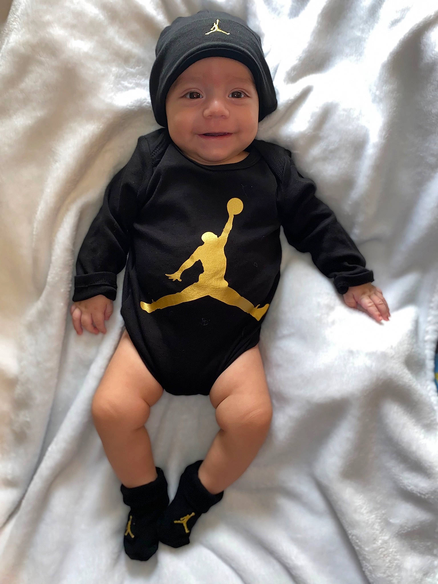 Ariel joined the competition — help win amazing prizes! baby, baby_products, baby_toddler_clothing, baseball_cap, cap, child, comfort, face, headgear, headwear, human_leg, joy, knee, linens, person, personal_protective_equipment, sitting, sleeve, smile, sock