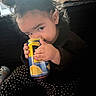 Penelope joined the competition — help win amazing prizes! child, toddler, curly_hair, sitting, drinking, beverage, juice, lemon, can, hands, face, eyes, portrait, indoors, couch, sunlight, polka_dot, clothing, snack, candid