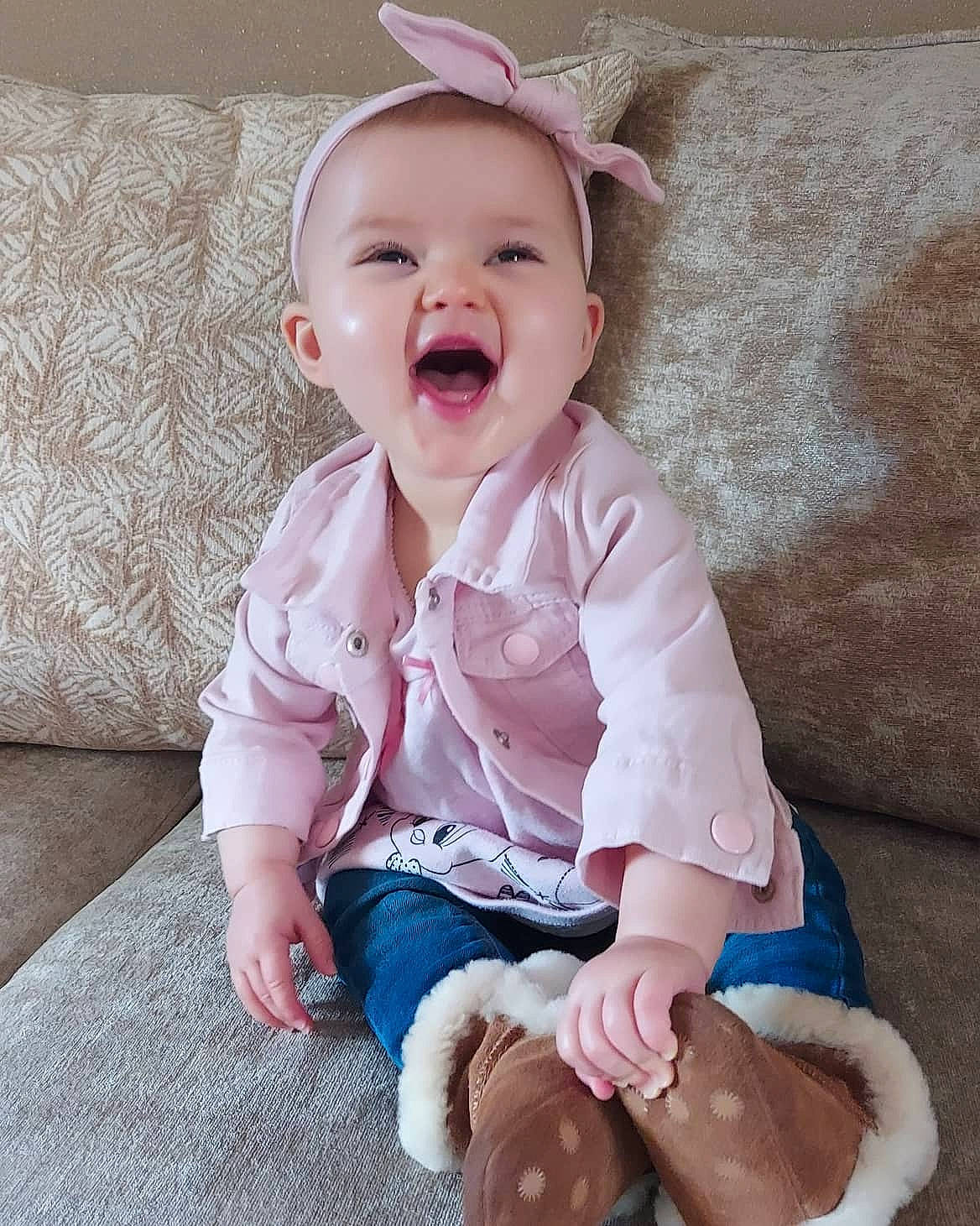Ava-mae is registered to the contest to win money with this photo: baby, baby_laughing, baby_making_funny_faces, baby_toddler_clothing, cheek, child, face, facial_expression, happy, head, leg, mouth, nose, person, pink, product, sitting, skin, sleeve, smile