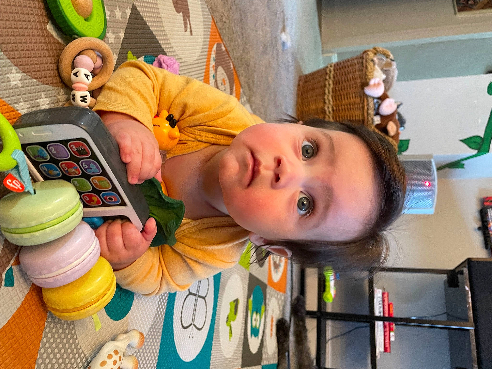 Emma is registered to the contest to win money with this photo: baby, baby_playing_with_toys, baby_toys, child, fun, green, happy, house, kindergarten, leisure, orange, party, person, play, room, shelf, sitting, surprise, toddler, toy