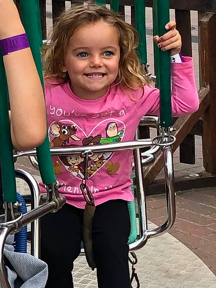 Bowbows is registered to the contest to win money with this photo: arm, blond, child, child_model, joy, magenta, person, pink, playground, recreation, smile, sportswear, style, swing, t_shirt, toddler, vacation