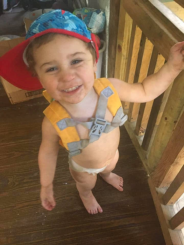 Parker is registered to the contest to win money with this photo: baby_toddler_clothing, child, finger, floor, flooring, foot, fun, hand, happy, hardwood, headwear, human_leg, joy, knee, person, skin, smile, standing, t_shirt, thigh