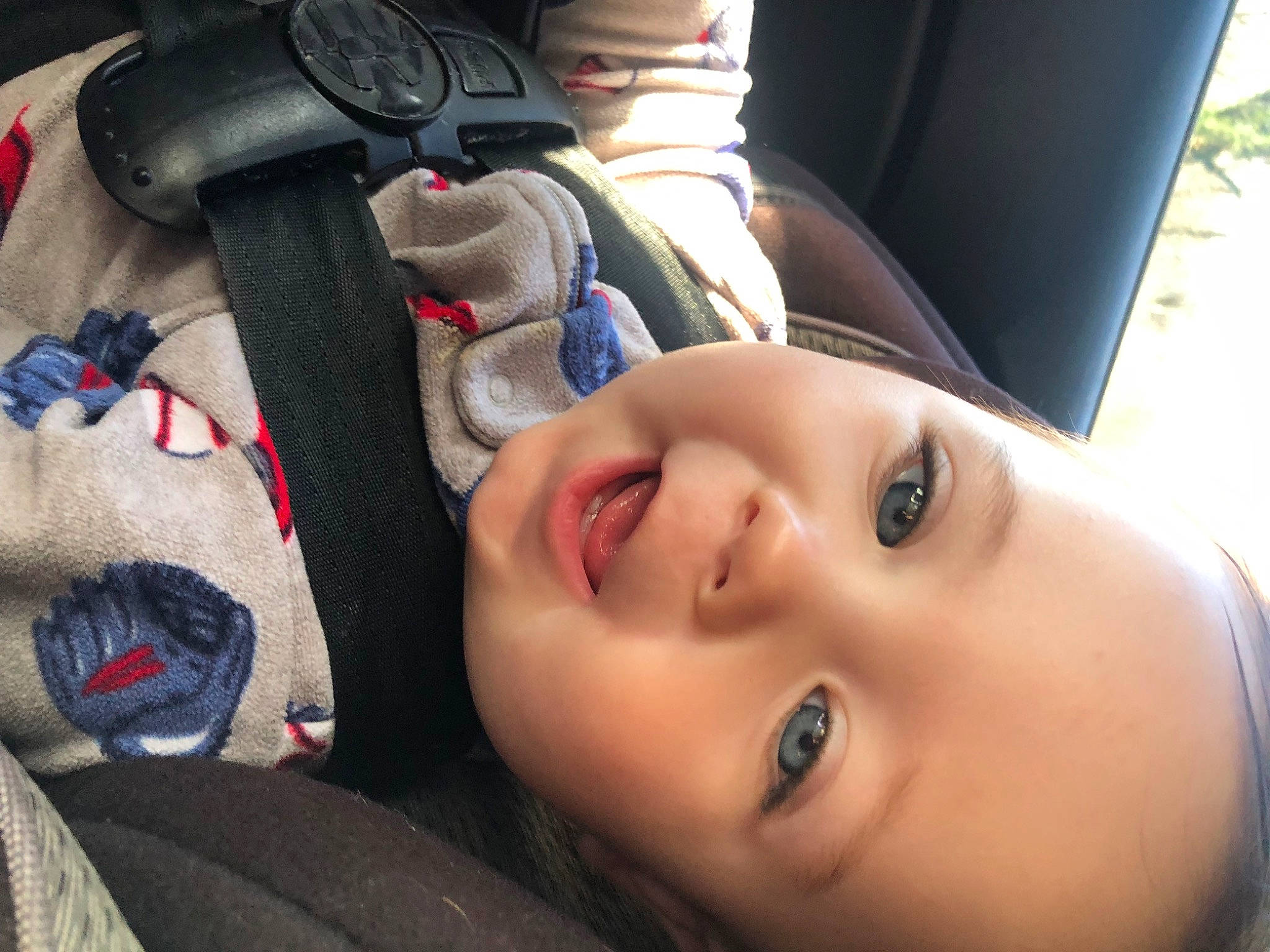 Kieran is registered to the contest to win money with this photo: audio_equipment, car_seat, child, cool, eyelash, eyewear, face, fun, happy, lip, mammal, mouth, nose, person, plant, skin, smile, steering_wheel, toddler, tree