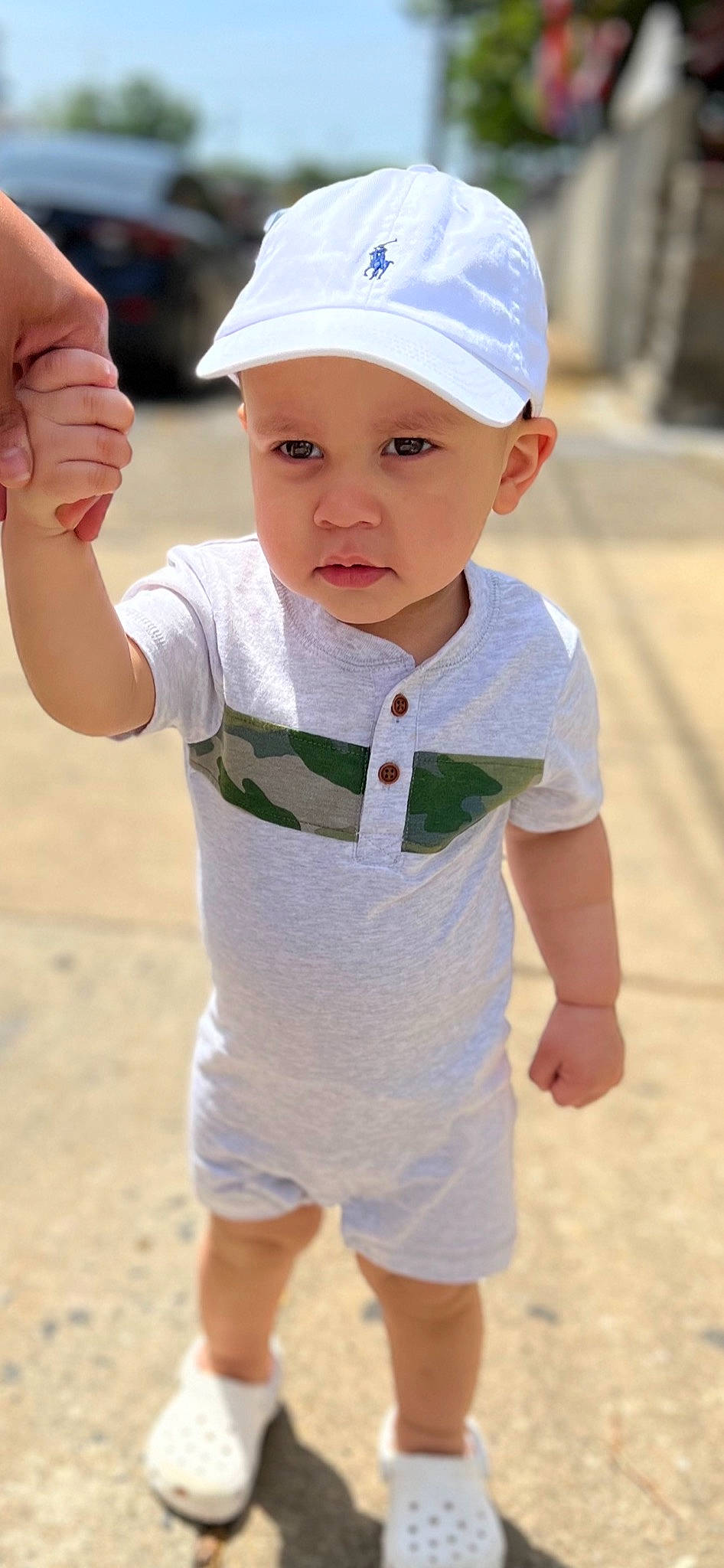 Kaysen is registered to the contest to win money with this photo: arm, baby, baby_toddler_clothing, cap, child, elbow, eye, finger, fun, gesture, hand, happy, headwear, joint, person, photograph, sand, sleeve, t_shirt, thumb