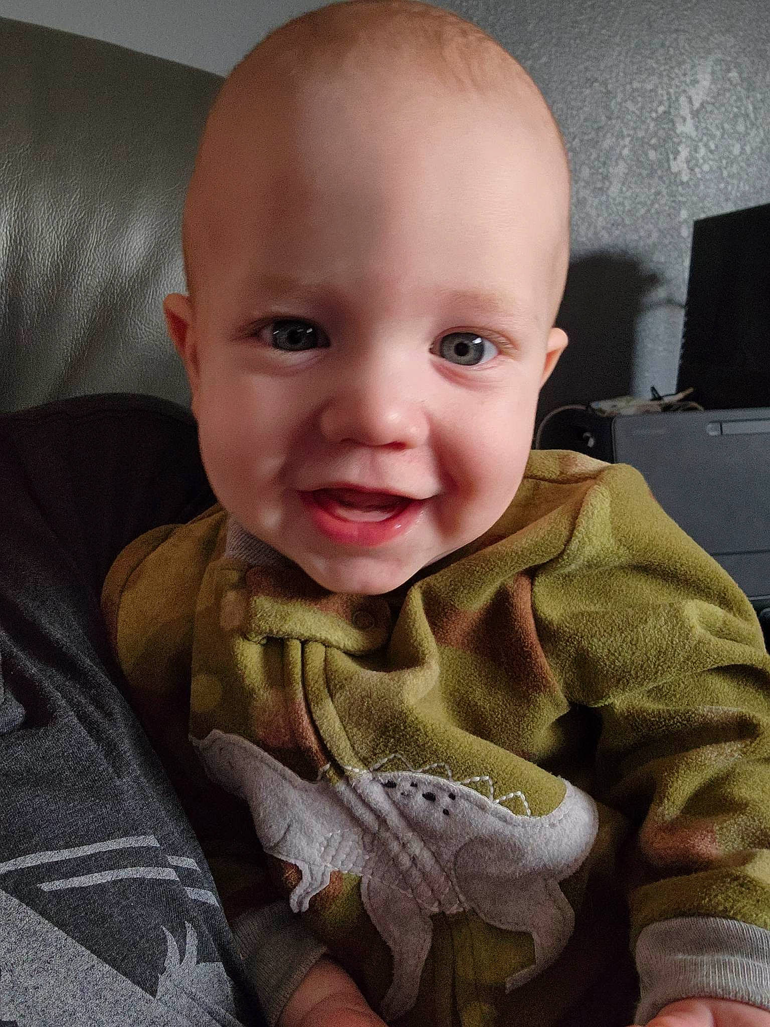 Ely is registered to the contest to win money with this photo: baby, baby_toddler_clothing, cheek, chin, comfort, ear, eye, eyebrow, happy, head, iris, linens, mouth, nose, person, sitting, skin, sleeve, smile, standing