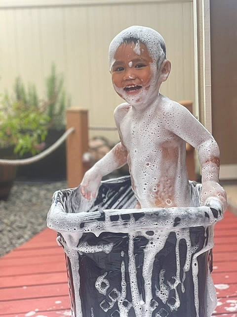 Hercules is registered to the contest to win money with this photo: art, child, eyewear, flowerpot, fountain, fun, happy, headwear, houseplant, laugh, lawn_ornament, leisure, person, plant, recreation, sitting, smile, visual_arts, waste_containment, water