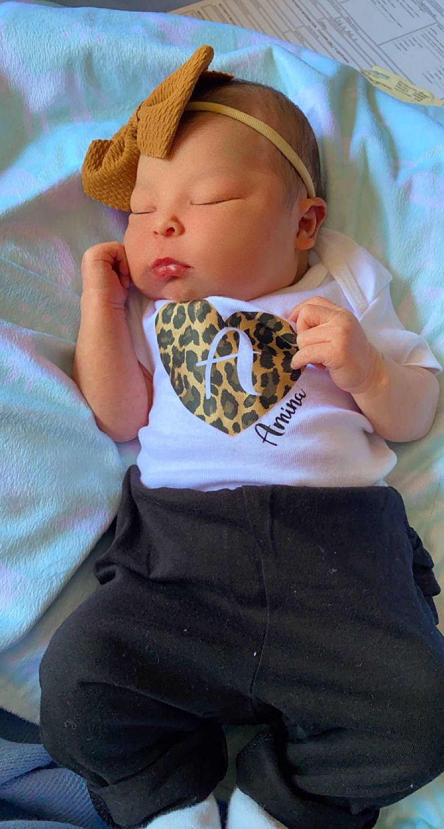 Amina is registered to the contest to win money with this photo: baby, baby_products, baby_toddler_clothing, cap, child, comfort, fashion_accessory, linens, pattern, person, pink, plaid, portrait_photography, sitting, skin, sleeve, sun_hat, t_shirt, textile, toddler