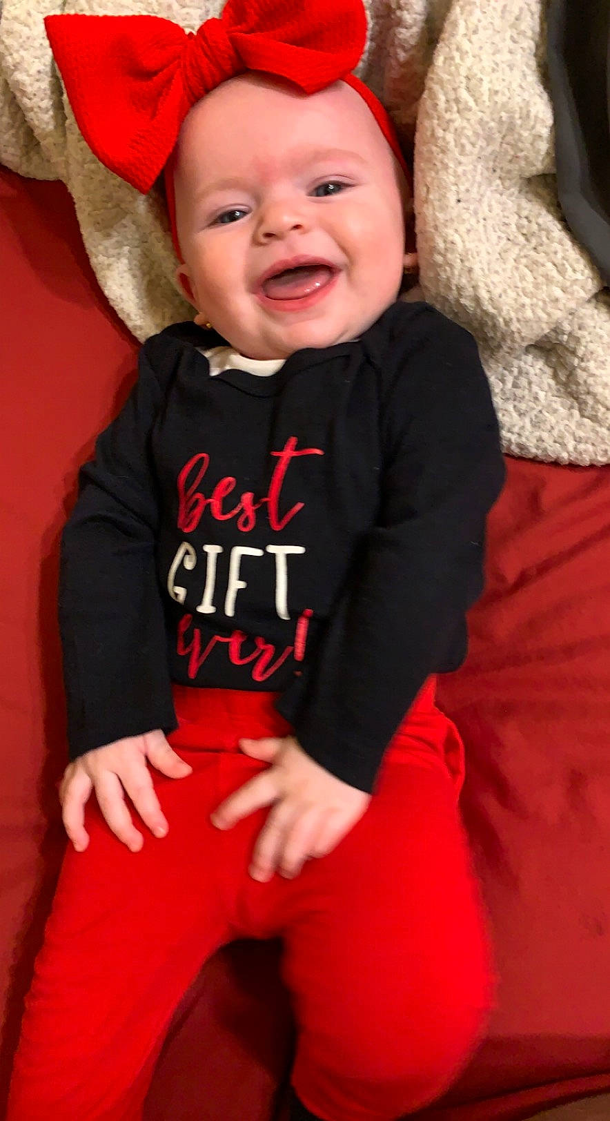 Skyler is registered to the contest to win money with this photo: baby, baby_toddler_clothing, black, cheek, chin, event, finger, fun, happy, headwear, human_body, lip, magenta, orange, person, pink, red, skin, sleeve, smile