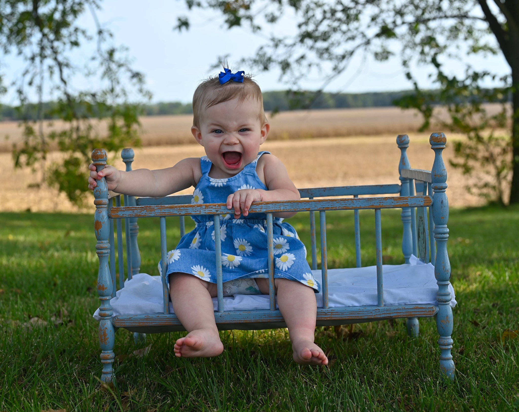 Bonnie is registered to the contest to win money with this photo: azure, baby, baby_toddler_clothing, child, electric_blue, face, flash_photography, fun, grass, happy, lawn, leisure, meadow, people_in_nature, person, plant, recreation, sky, smile, toddler
