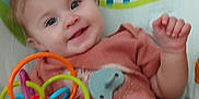 Ashlynn is registered to the contest to win money with this photo: baby, background, bird_design, child, clothing, colorful, cushion, cute, face, foot, hand, happy, indoor, infant, pacifier, person, play, seat, smiling, toy