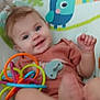 baby, background, bird_design, child, clothing, colorful, cushion, cute, face, foot, hand, happy, indoor, infant, pacifier, person, play, seat, smiling, toy