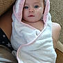 baby, blanket, blue_eyes, carpet, child, closeup, comfort, couch, curly_hair, face, home, indoor, person, pink_trim, portrait, resting, seated, soft_texture, towel, wrapped