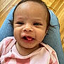 Violet is registered to the contest to win money with this photo: baby, infant, smile, tongue, face, person, clothing, pink, jeans, lap, wood_floor, happy, cute, child, young, indoors, close_up, human, skin, hair