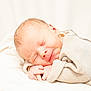 newborn, baby, sleeping, smile, cozy, sweater, infant, soft, white_background, peaceful, cute, resting, portrait, child, human, skin, closed_eyes, tiny_hands, warm, comfort