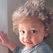 Maze joined the competition — help win amazing prizes! toddler, child, curly_hair, face, portrait, indoor, hand, wall, clothing, person, young_child, cute, expression, looking_away, soft_light, casual, skin, head, eyes, hair