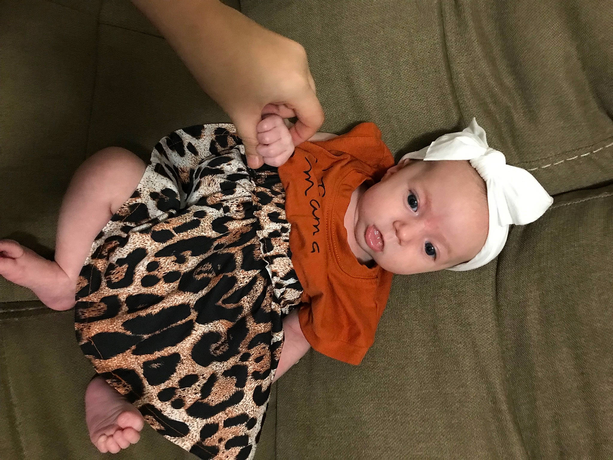 Mckinley is registered to the contest to win money with this photo: baby, baby_toddler_clothing, cheek, child, comfort, finger, gesture, hand, hat, headgear, human_body, iris, mammal, outerwear, pattern, person, skin, sleeve, textile, toddler