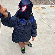 Jaziel Liam Gray joined the competition — help win amazing prizes! child, costume, spiderman_mask, jacket, outdoor, sidewalk, tree, playful, pose, concrete, shoes, street, brown_pants, green_stripes, masked_face, casual_wear, winter_clothing, urban, kid, fun