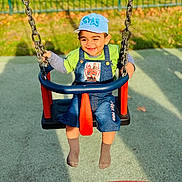 Burhan joined the competition — help win amazing prizes! child, toddler, swing, playground, cap, smiling, outdoor, sunlight, greenery, fence, shorts, socks, happy, clothing, person, play, fun, daylight, joy, casual