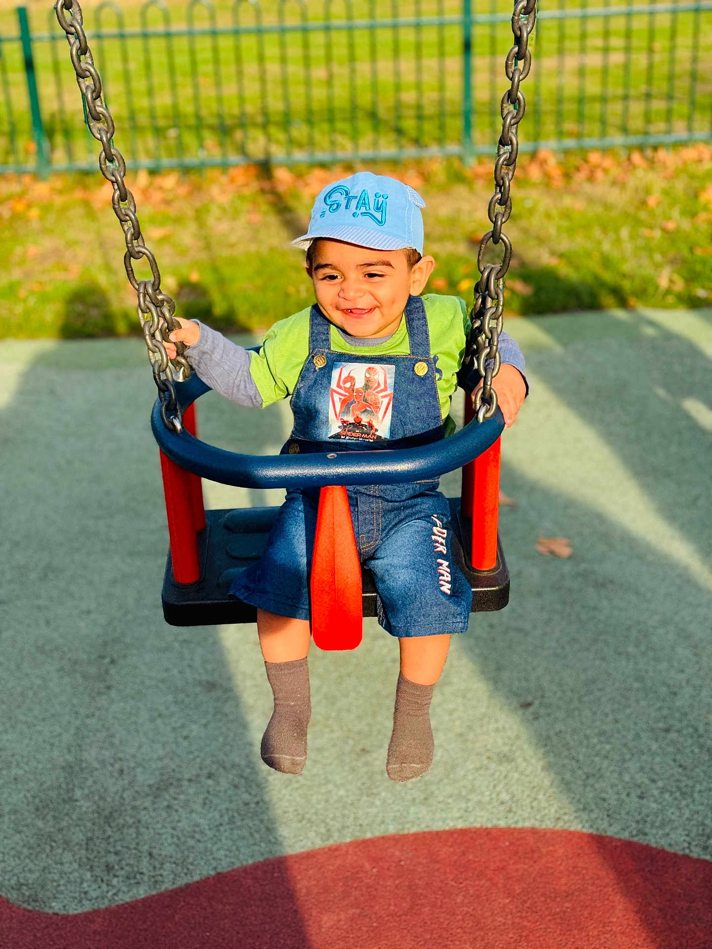 Burhan joined the competition — help win amazing prizes! child, toddler, swing, playground, cap, smiling, outdoor, sunlight, greenery, fence, shorts, socks, happy, clothing, person, play, fun, daylight, joy, casual