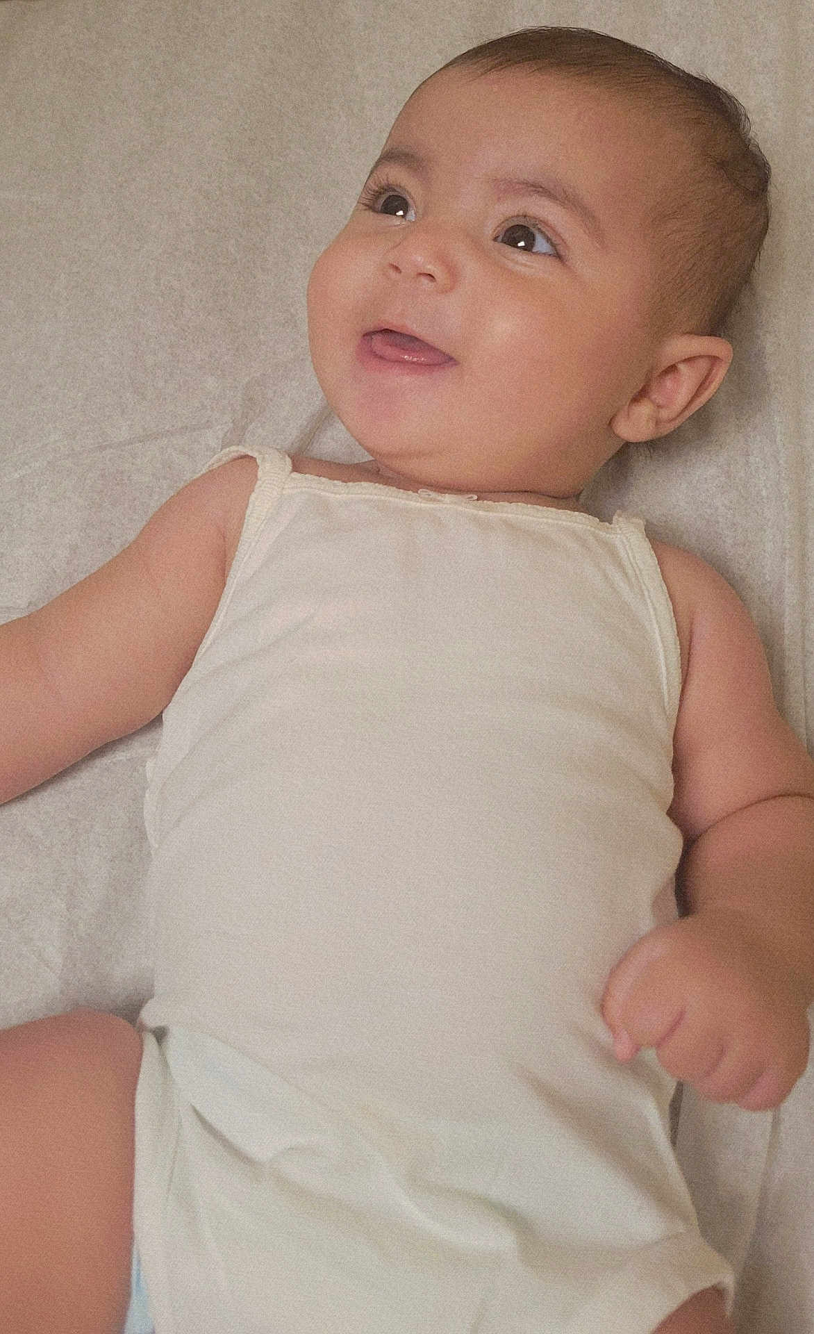 Nadia joined the competition — help win amazing prizes! baby, infant, smiling, happy, lying_down, onesie, skin, face, arm, hand, child, cute, portrait, young, person, indoors, sleepwear, toddler, expression, closeup