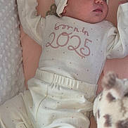 Aleri is registered to the contest to win money with this photo: baby, newborn, sleeping, pajamas, hat, blanket, cushion, plush_toy, soft, pink, white, infant, child, indoors, cozy, resting, cute, face, peaceful, nursery