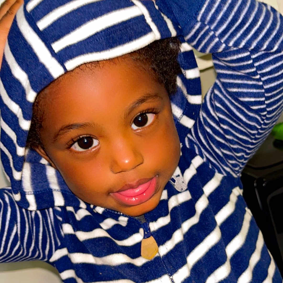 Jackie Russell is registered to the contest to win money with this photo: accessories, baby, baseballcap, cap, clothing, dimples, face, happy, hat, head, hood, hoodie, knitwear, person, photography, portrait, sleeve, smile, sweater, sweatshirt