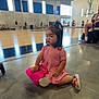 Milli is registered to the contest to win money with this photo: action, basketball_court, casual, child, childhood, colorful_shoes, concrete_floor, daylight, gymnasium, indoor, people, pink_dress, playful, sitting, spectators, sports, team_sport, toddler, toy_purse, young_child
