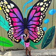 Dalliyah is registered to the contest to win money with this photo: art, child, city, clothing, costume, face, female, footwear, girl, head, person, photography, portrait, purple, road, sandal, shoe, shorts, street, urban