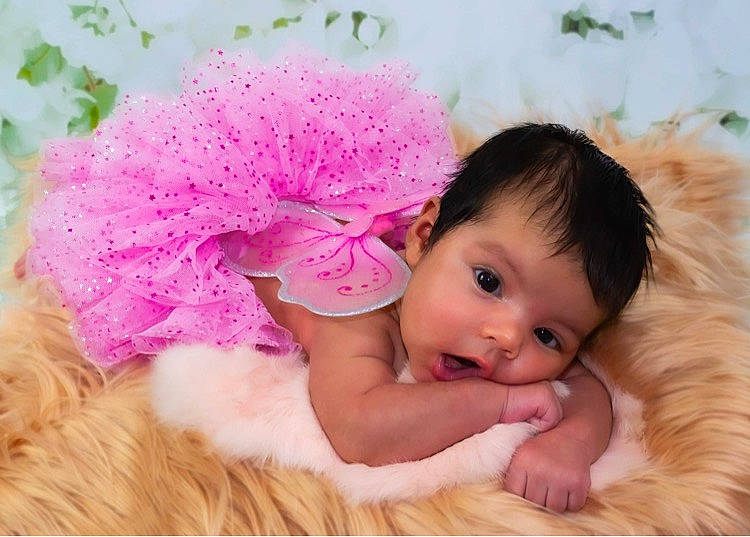 Evelina is registered to the contest to win money with this photo: animal_product, baby, baby_toddler_clothing, cheek, child_model, fur, fur_clothing, hair_accessory, headband, love, magenta, natural_material, peach, person, petal, photography, pink, portrait_photography, rhododendron, skin