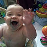 Adam is registered to the contest to win money with this photo: baby, child, smiling, waving, indoor, toy, walker, happy, face, messy, playful, colorful, infant, person, furniture, background, home, cute, cheerful, young