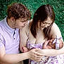 Adaline is registered to the contest to win money with this photo: family, newborn, baby, mother, father, outdoor, grass, love, tenderness, child, holding, headband, floral_dress, smile, together, nature, caring, young_adult, parenthood, affection