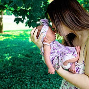 Adaline joined the competition — help win amazing prizes! baby, woman, kiss, outdoor, nature, greenery, floral_dress, headband, affection, mother, child, love, portrait, holding, sunlight, grass, tree, tenderness, closeup, family