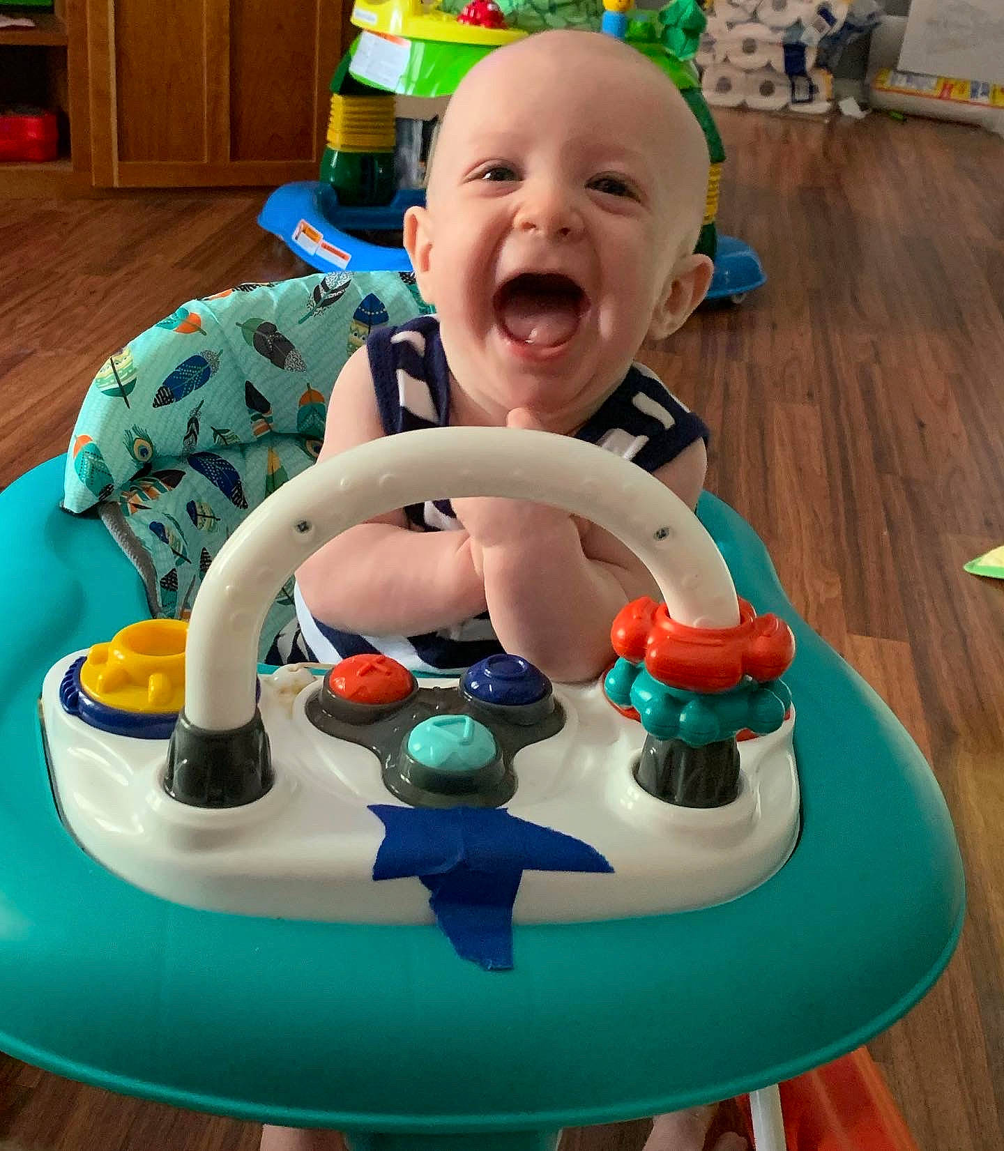 Liam joined the competition — help win amazing prizes! baby, baby_products, baby_toddler_clothing, baby_toys, cabinetry, child, circle, face, fun, green, happy, icing, leisure, person, plastic, play, sitting, smile, toddler, toy