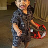 Royal is registered to the contest to win money with this photo: toddler, child, smiling, barefoot, indoor, carpet, shorts, shirt, patterned_clothing, happy, person, young_child, standing, bag, shopping_bag, home, room, floor, cute, portrait