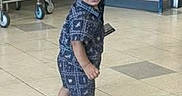 Royal is registered to the contest to win money with this photo: toddler, child, barefoot, indoor, floor, shopping_cart, machine, tile_floor, blue_outfit, smiling, walking, curious, store, background, young_child, person, standing, happy, shorts, patterned_clothing