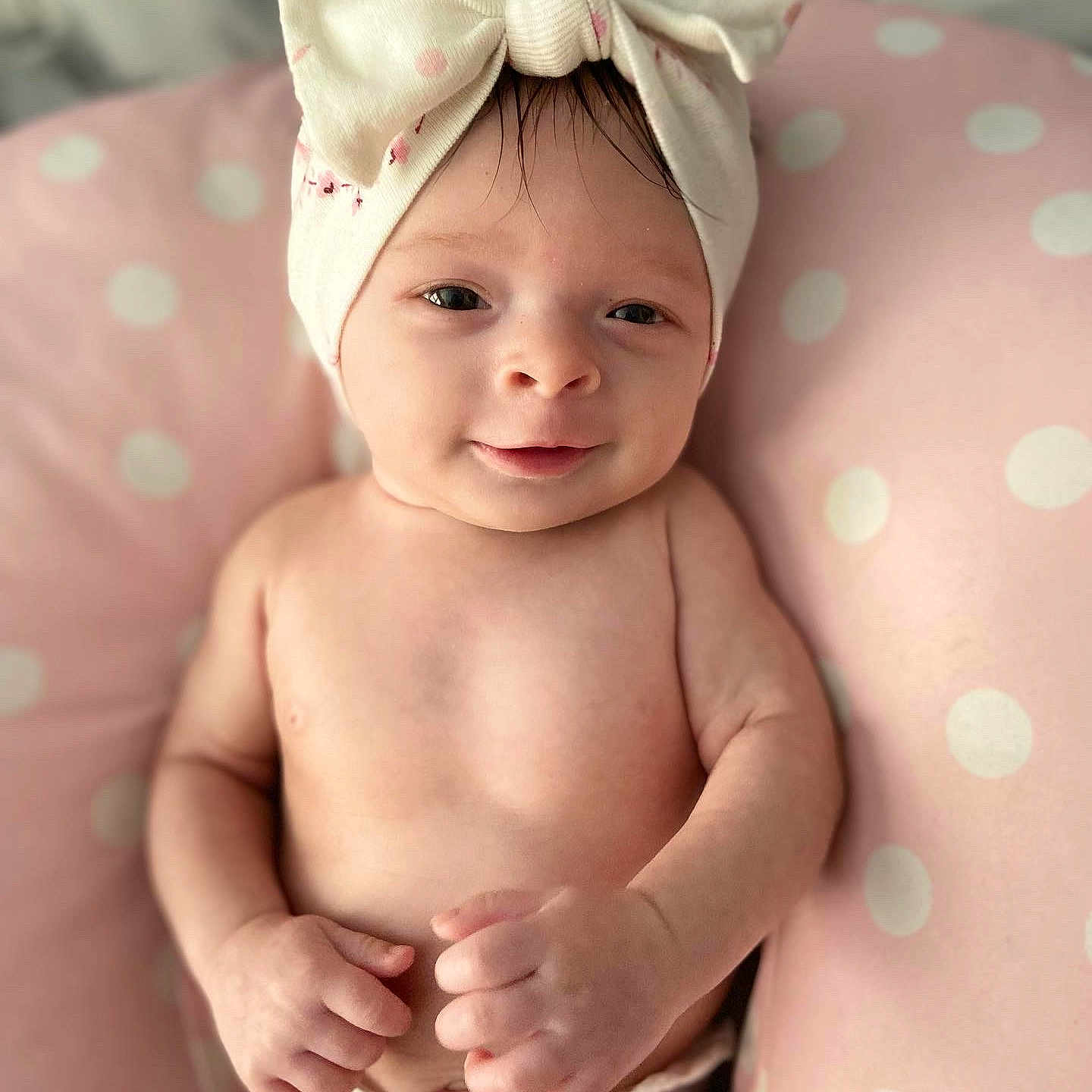 Thalia is registered to the contest to win money with this photo: baby, cap, cheek, chin, eye, eyebrow, face, finger, happy, head, human_body, iris, lip, neck, pink, skin, smile, stomach, toddler, white