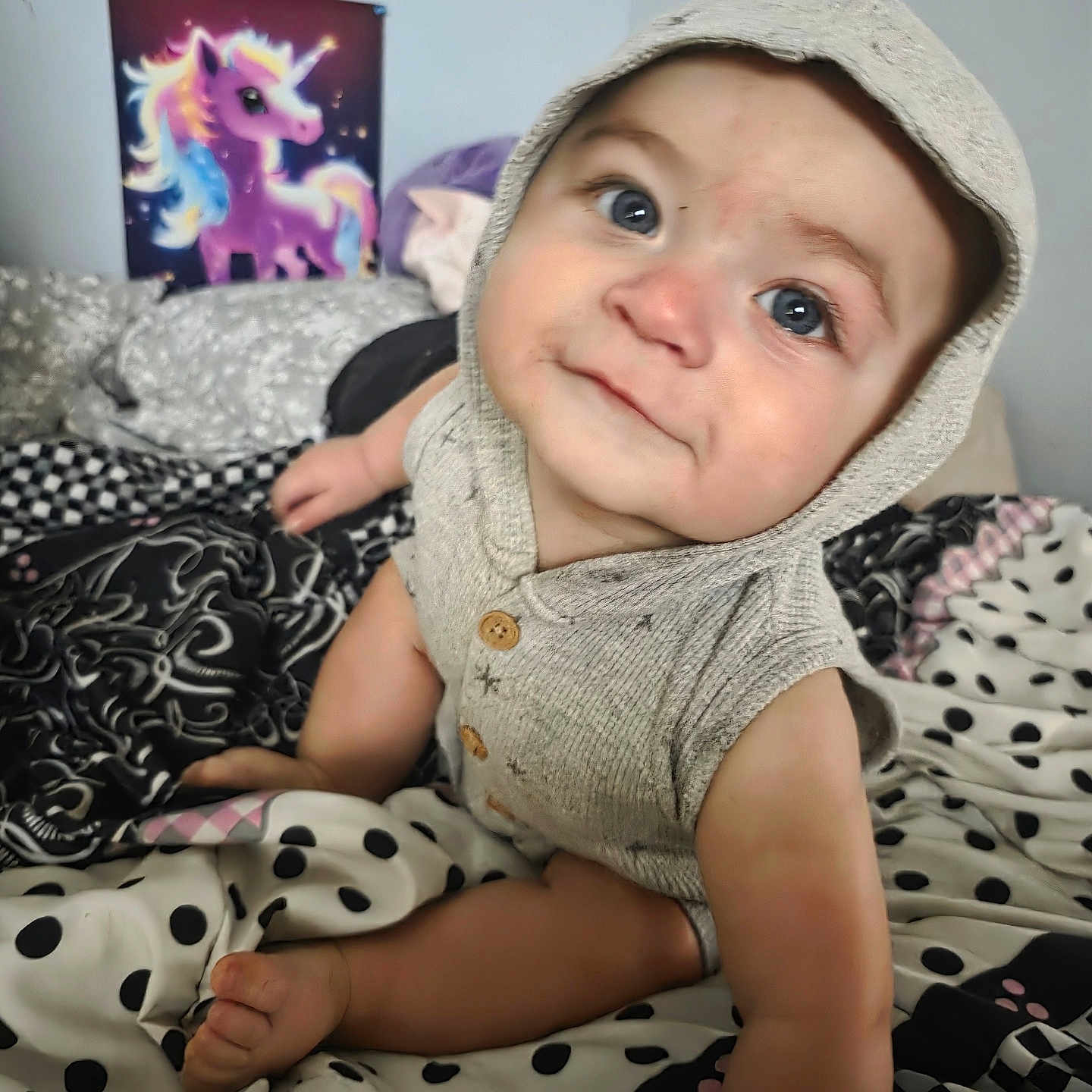 Skyler joined the competition — help win amazing prizes! baby, child, hoodie, bed, blanket, polka_dots, poster, unicorn, indoor, cute, crawling, person, face, blue_eyes, furniture, room, soft_lighting, clothing, expression, infant