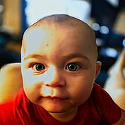 Skyler joined the competition — help win amazing prizes! baby, child, face, eyes, red_shirt, indoor, portrait, closeup, curious, young, skin, head, person, infant, expression, childhood, human, cute, baby_boy, focus