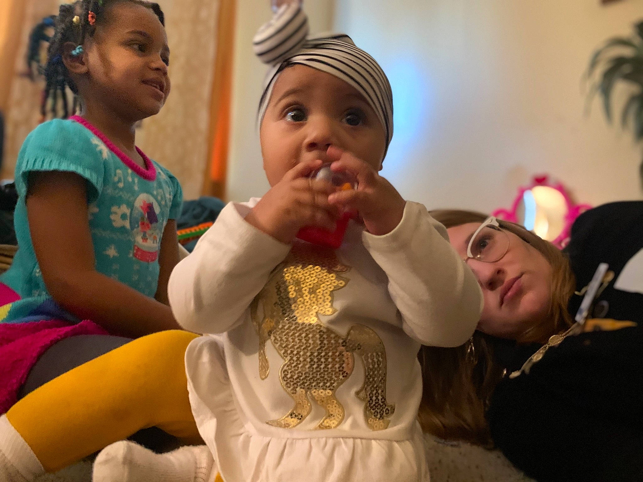 Venus is registered to the contest to win money with this photo: child, event, fun, gesture, happy, headwear, jewellery, leisure, necklace, person, room, surprise, tradition, tree, vacation